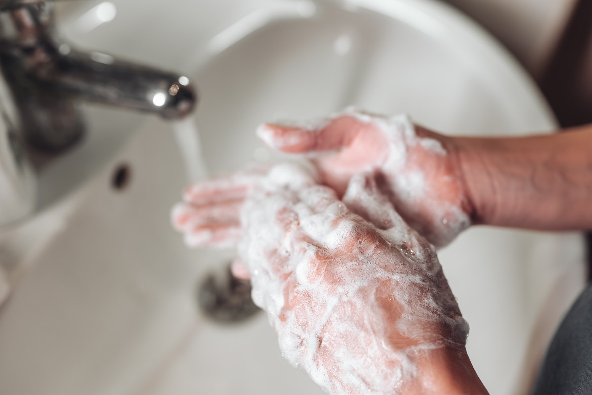 Man washing hands to protect against the coronavirus