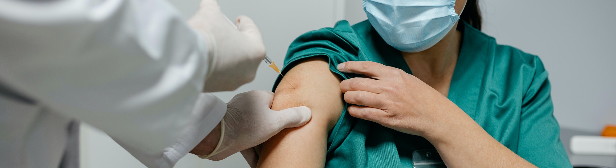 Female surgeon receiving coronavirus vaccine