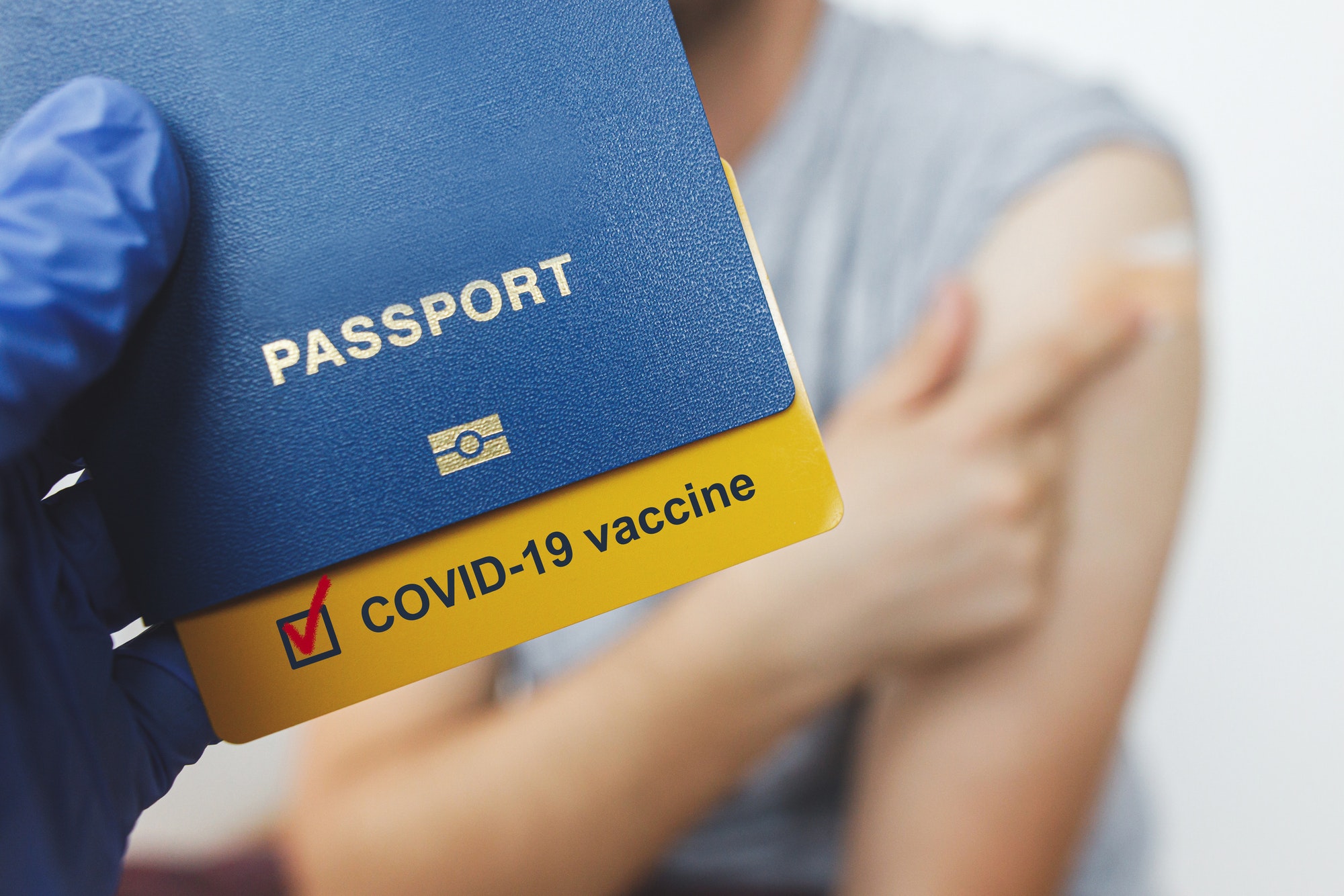 Coronavirus Vaccination passport. Passport with covid-19 vaccine certificate in hand after injection