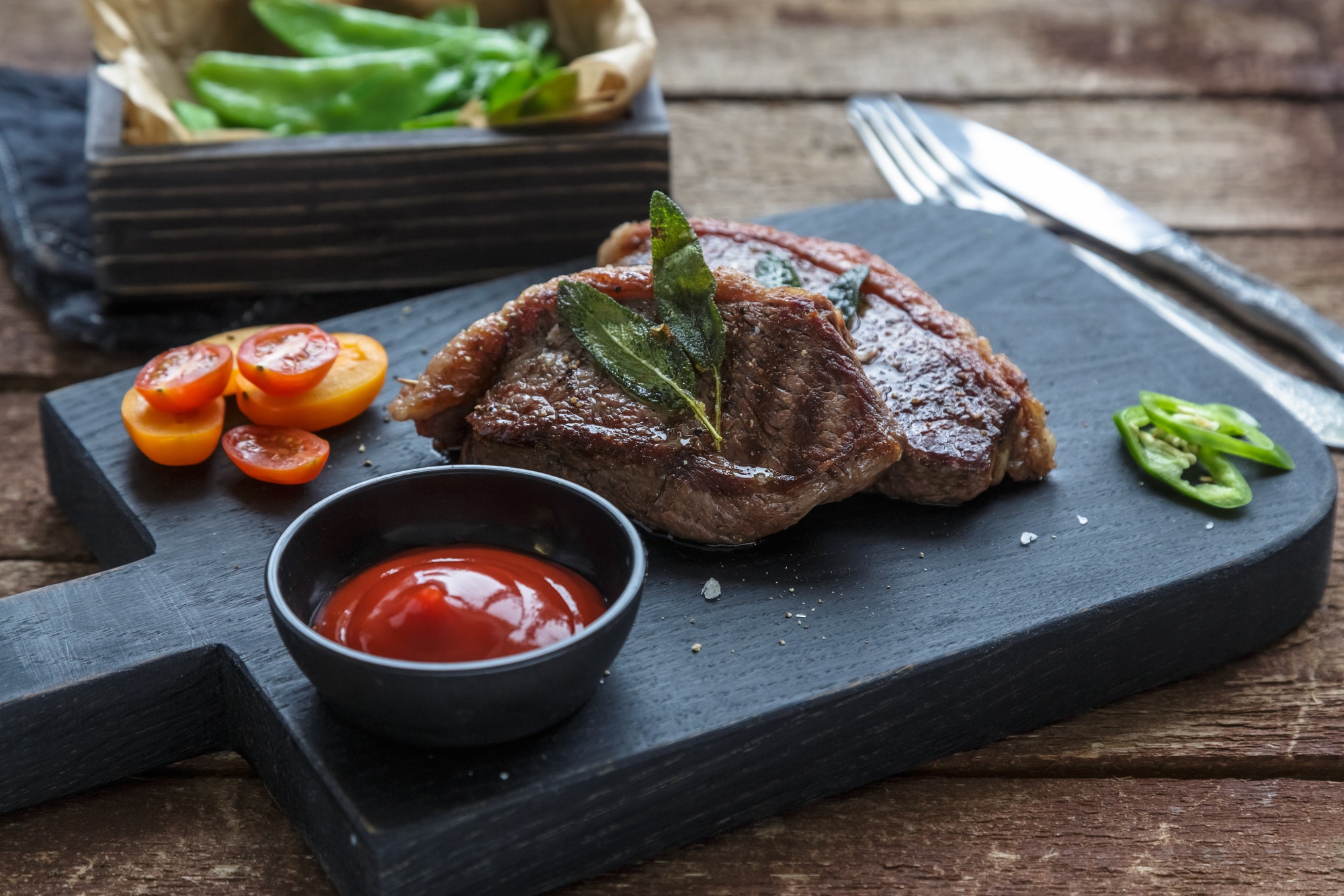 Meat Picanha steak, traditional Brazilian cut on black cutting board.