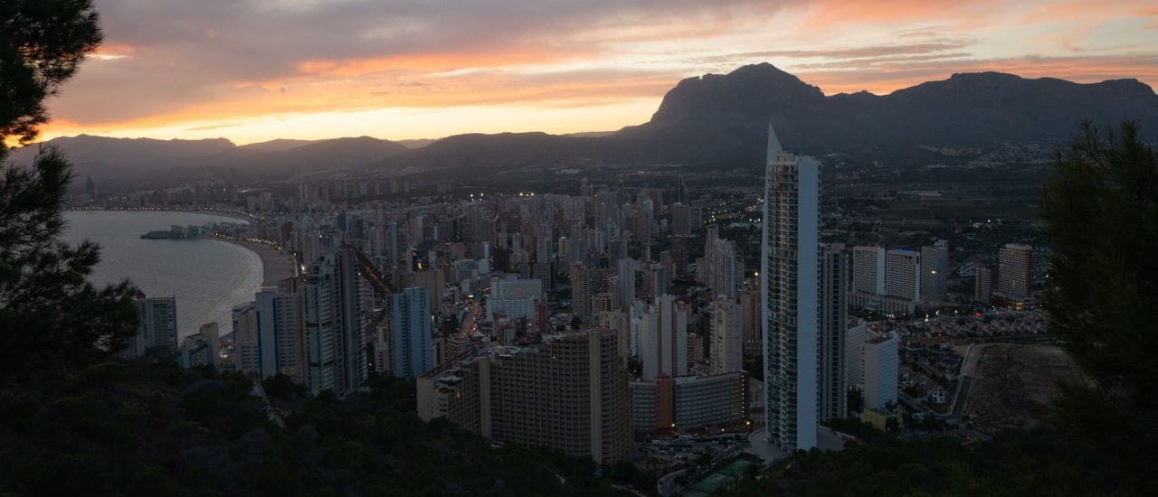 coastal city with modern architecture under sundown sky
