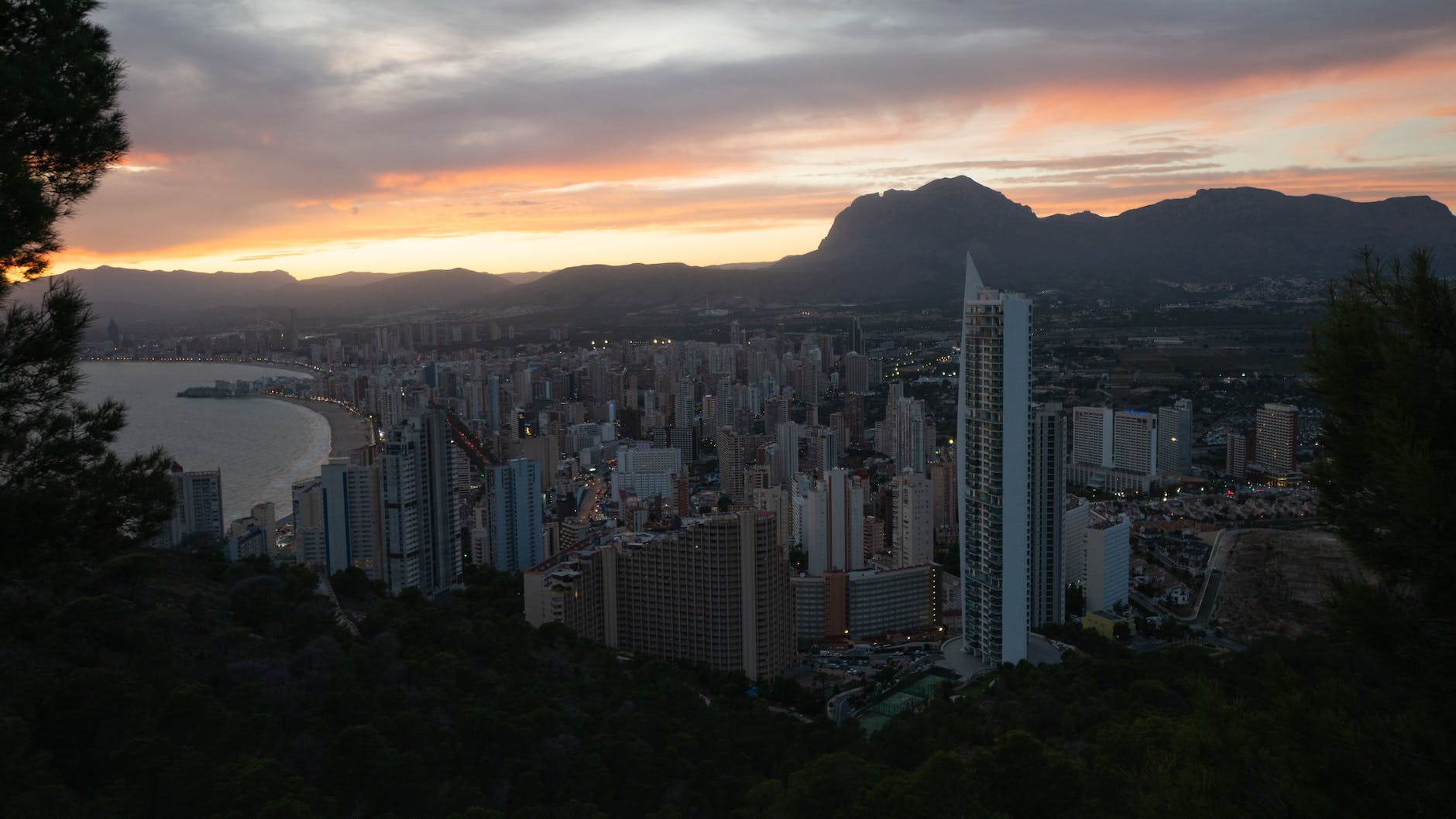 coastal city with modern architecture under sundown sky