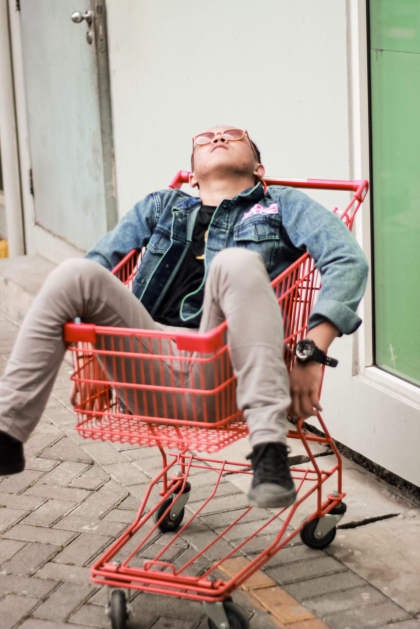 Man relaxing on a shopping trolley