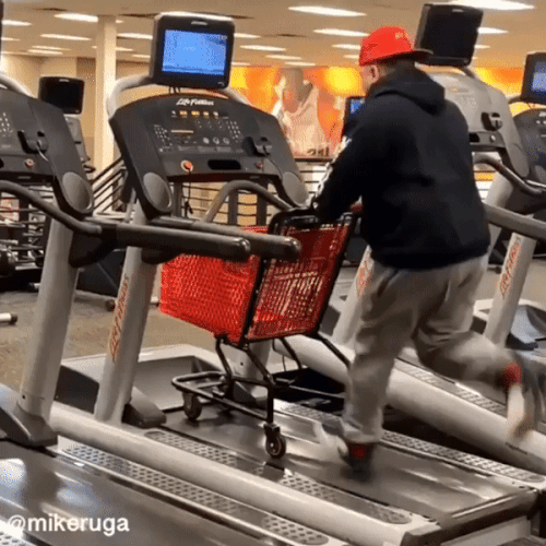 A man running on treadmill with a shopping cart