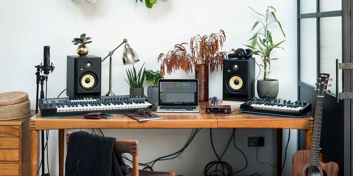 Desktop studio monitors with a laptop and midi keyboards