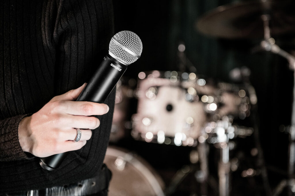 The Shure BLX wireless system and mic in use with drums behind