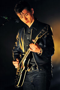Alex Turner frontman of Arctic Monkeys performing with a Gibson Les Paul