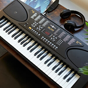 MK-3000 keyboard and headphones by Gear4music on a wooden desk with a plant next to it 