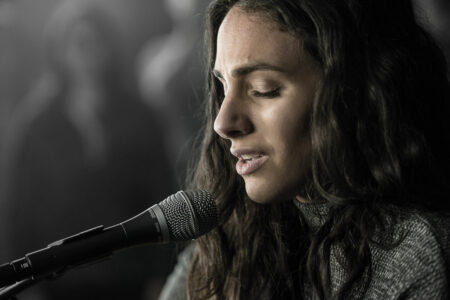 Female singer using the Shure SM86 microphone with her eyes closed