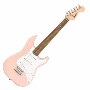 The Squier Mini Stratocaster 3/4 Size in Shell Pink posed at an angle with a white background