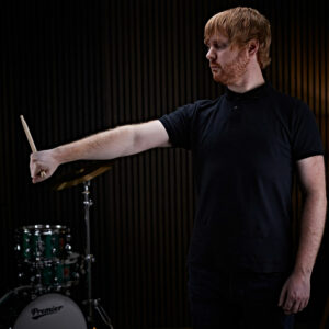 A man warming up his wrist before drumming