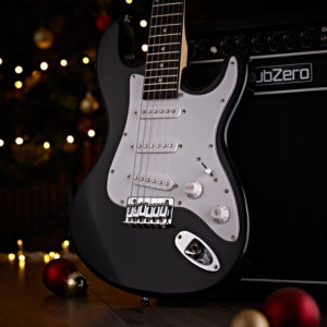 The 3/4 LA Electric Guitar stood against a Subzero amp, surrounded by Christmas lights and baubles