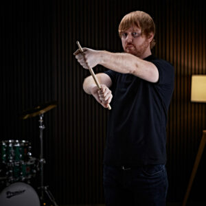 A man stretching his arms before drumming