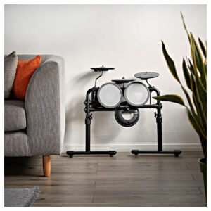 The VISIONDRUM Compact Mesh Electronic Drum Kit packed away against a wall