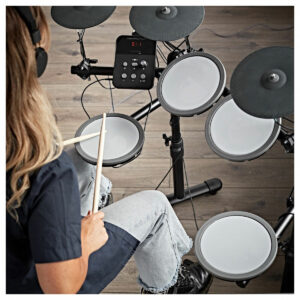 A girl playing the VISIONDRUM Compact Mesh Electronic Drum Kit