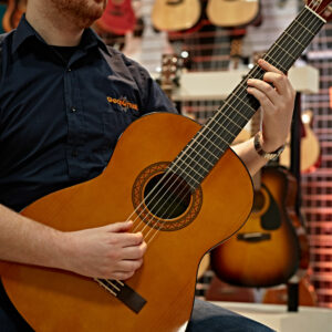 A guitarist playing the Yamaha CX40 Electro Classical Guitar 