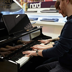 Two pianists playing a Casio hybrid grand piano 