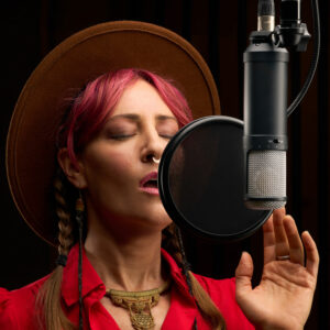 A singer using the Universal Audio LX mic with a pop shield