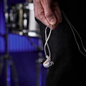 A musician carrying Shure SE215 Sound Isolating Earphones