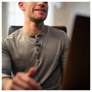 A lavalier mic clipped to a man's shirt