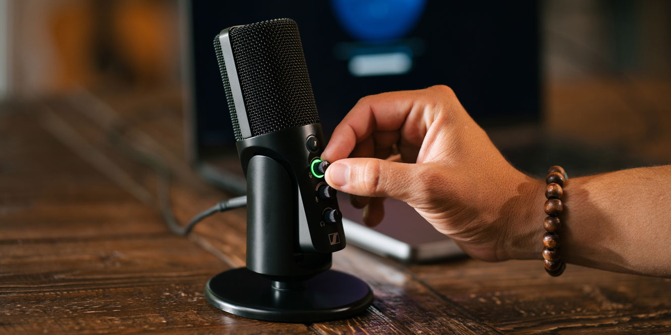 The Sennheiser Profile mic on a desk with a laptop 