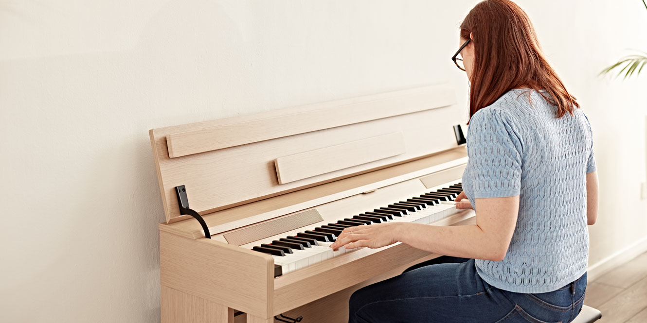 A pianist playing the DP-12 Compact Digital Piano by Gear4music