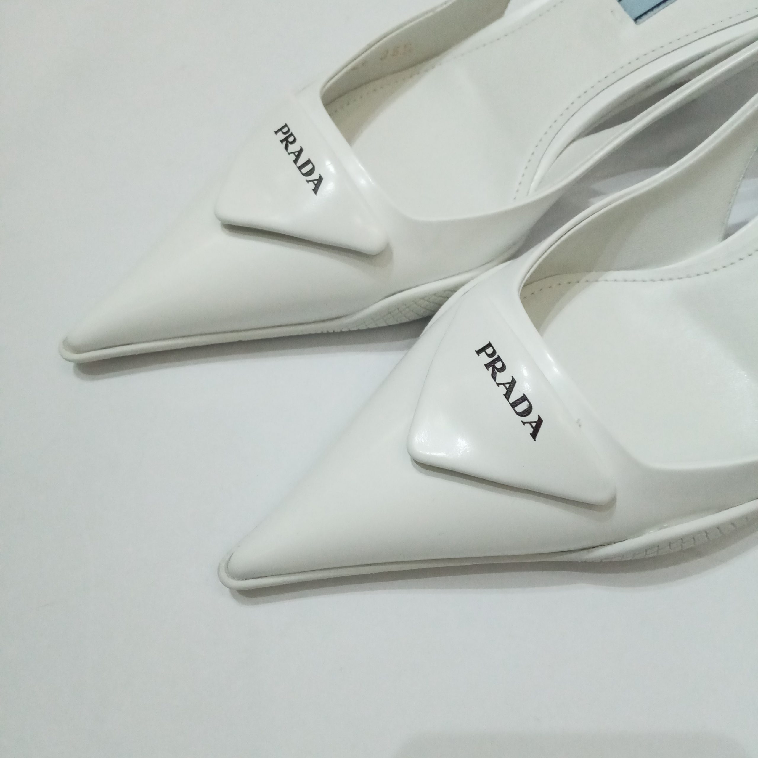 WHITE OUT: Get a handle on @prada's sleek silhouettes. Adding an