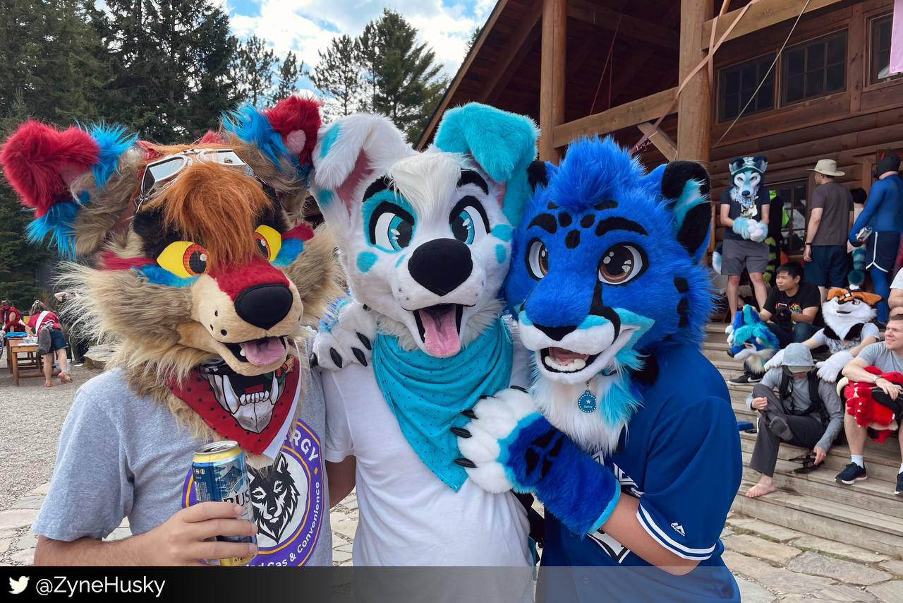 3 fursuiters in front of main lodge