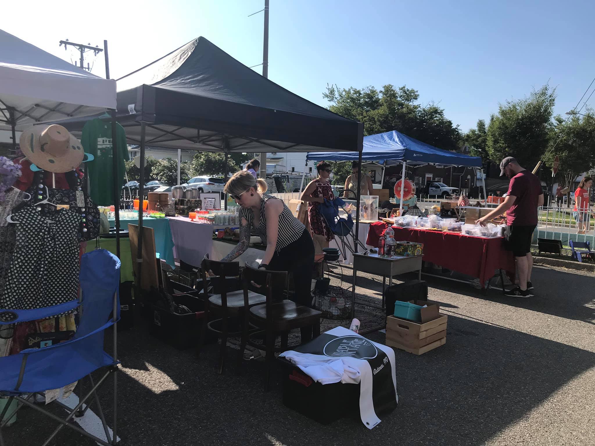 woman looks at vintage items at flea market