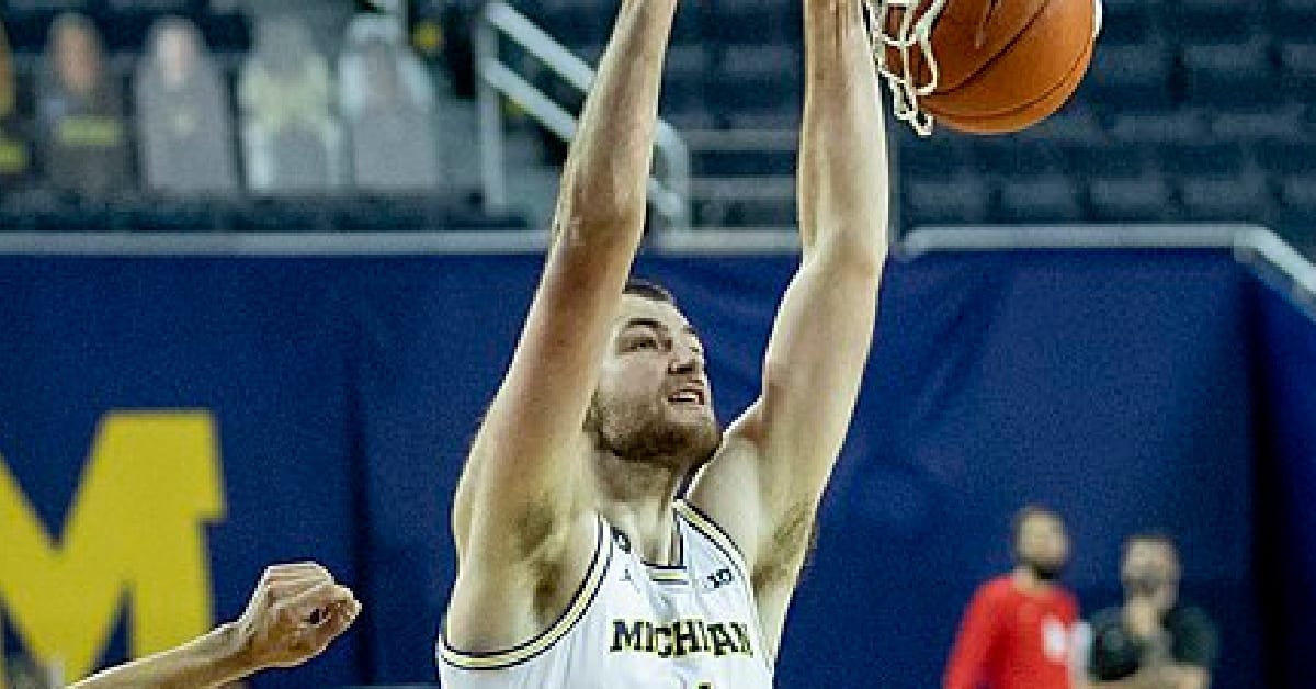 Hunter DIckinson dunking ball in basket.