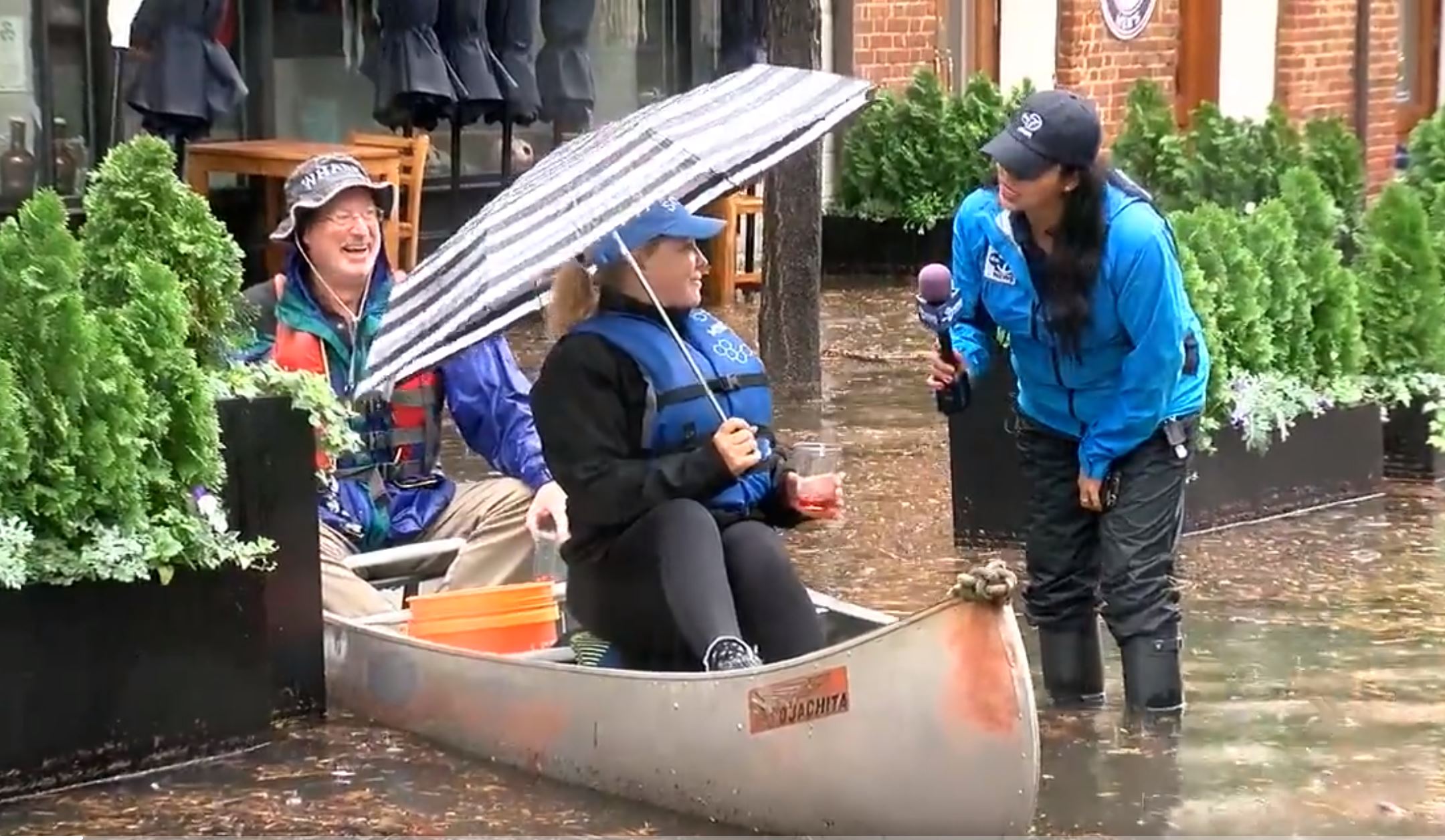 Local news reporter for Channel 7, Victoria Sanchez, interviews canoing couple during October 29, 2021 flood in Old Town Alexandria. (Courtesy photo)