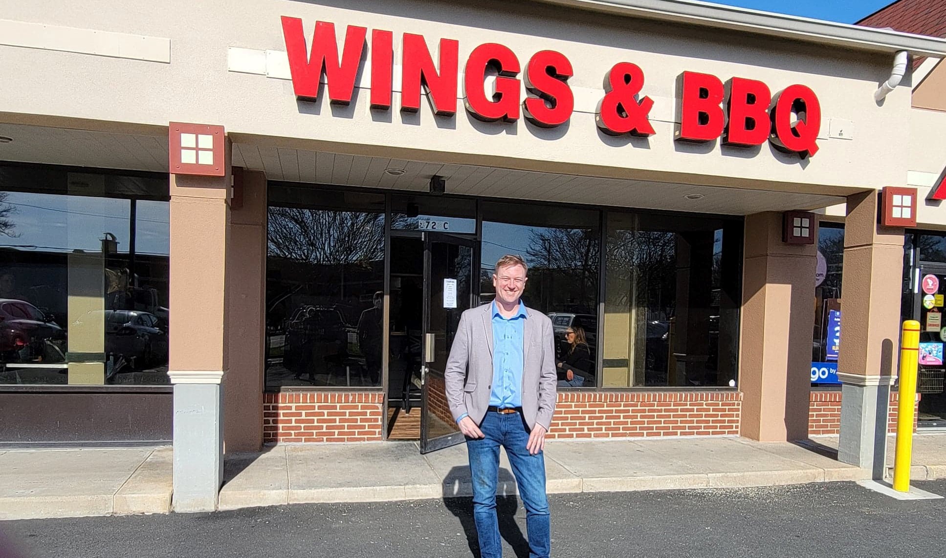 C.J. Cross in front of the new Chalkboard Wings and BBQ (Photo: Debby Critchley)