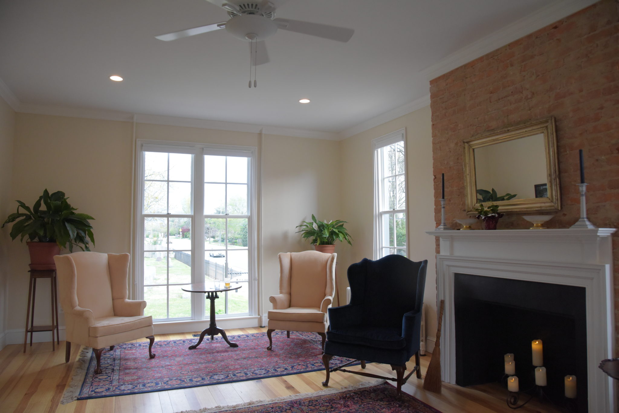 a sitting room with antique chars and rugs