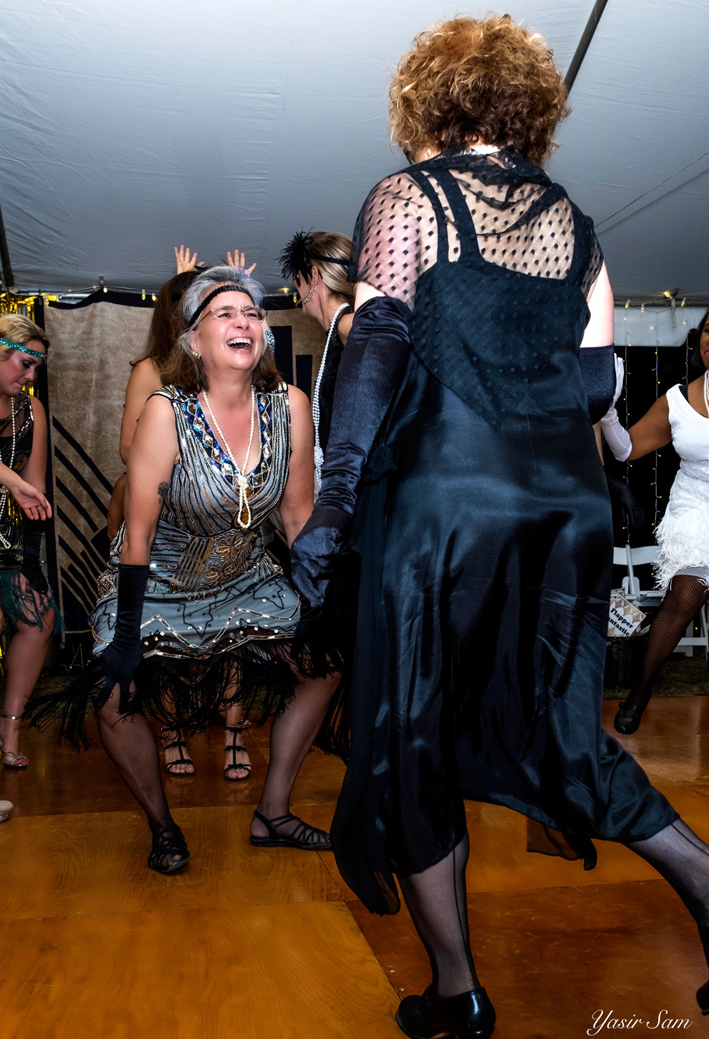 two women in flapper dresses on dance floor