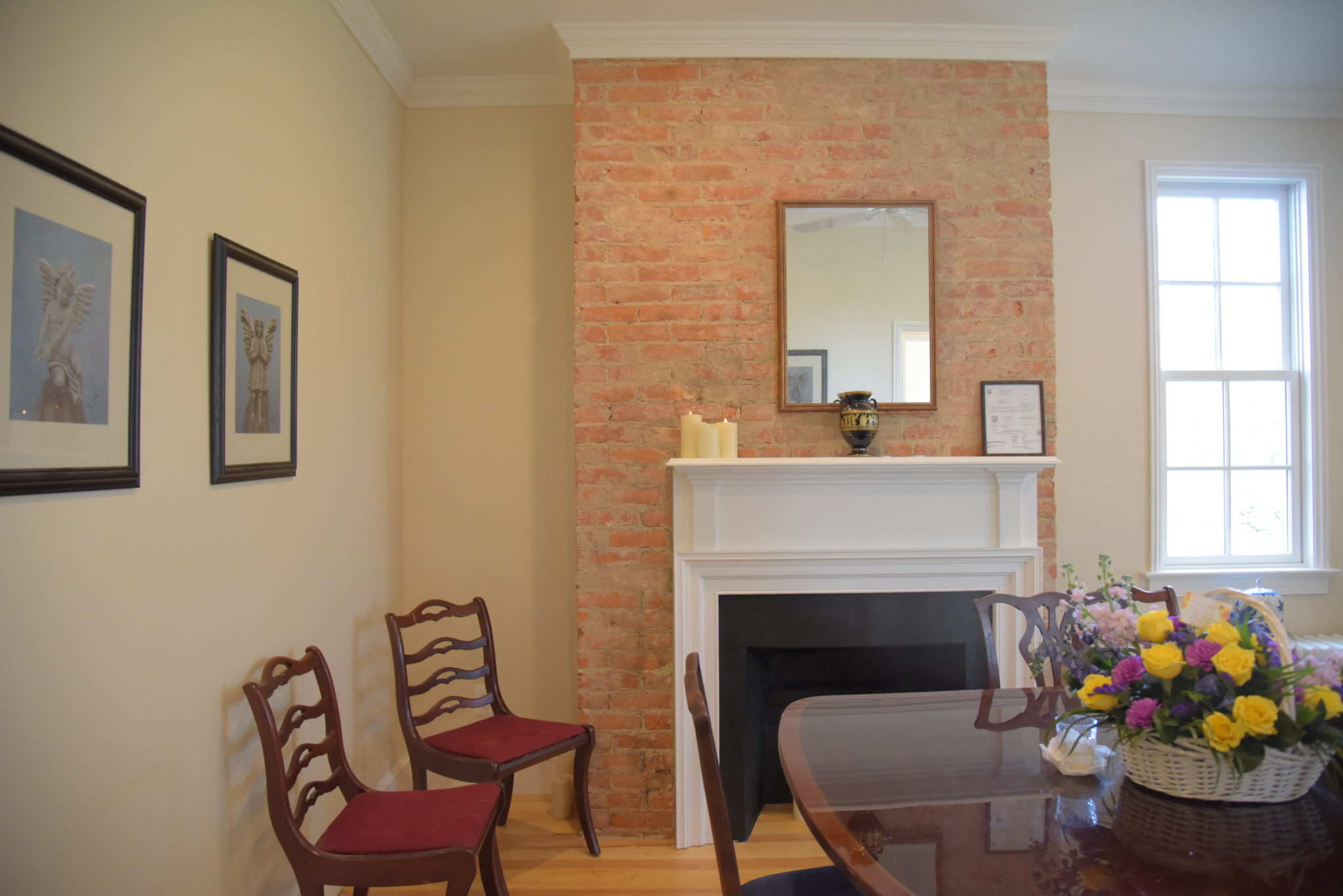antique chairs next to a brick fireplace