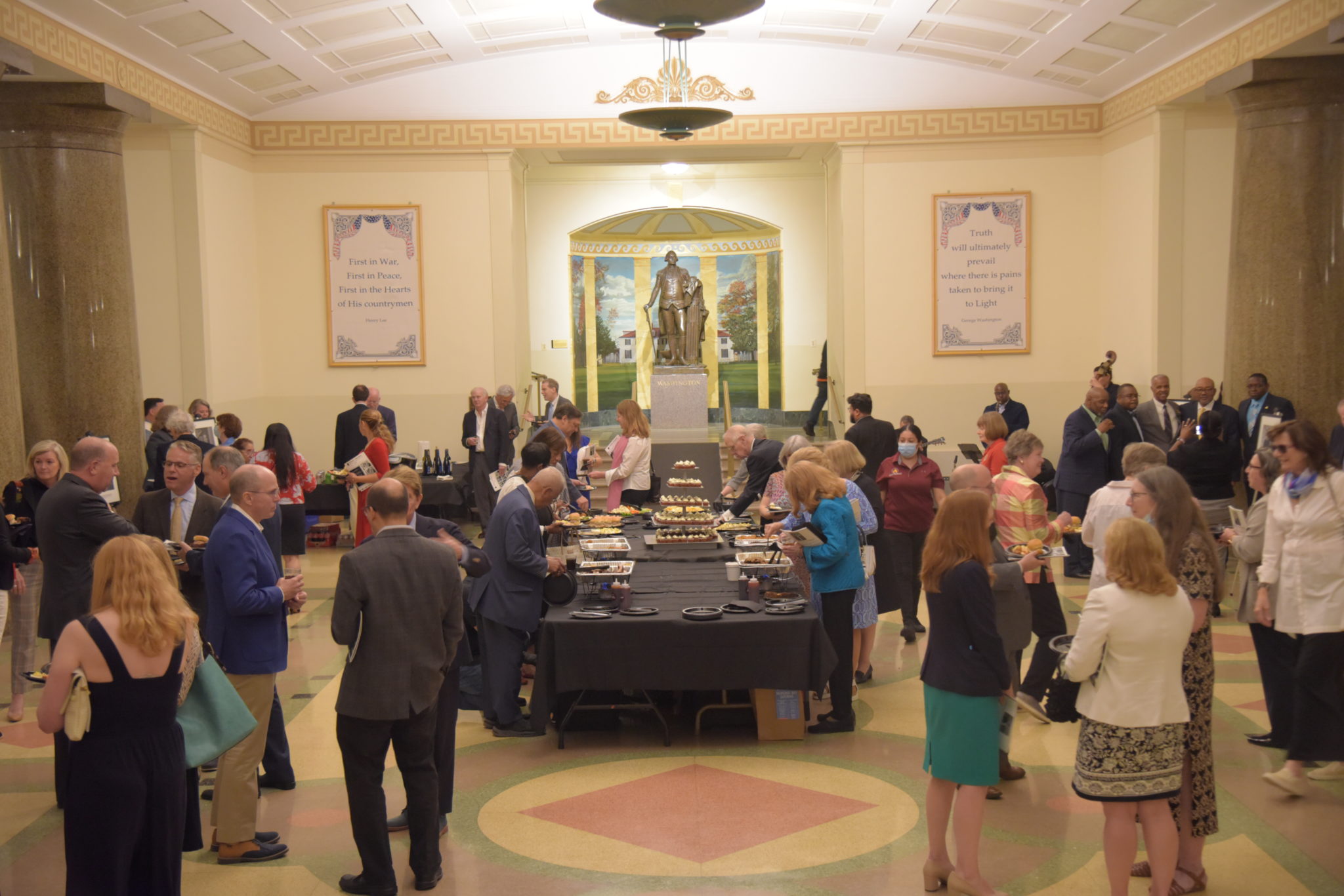 crowd peruses a buffet in the great hall of the Masonic Memorial