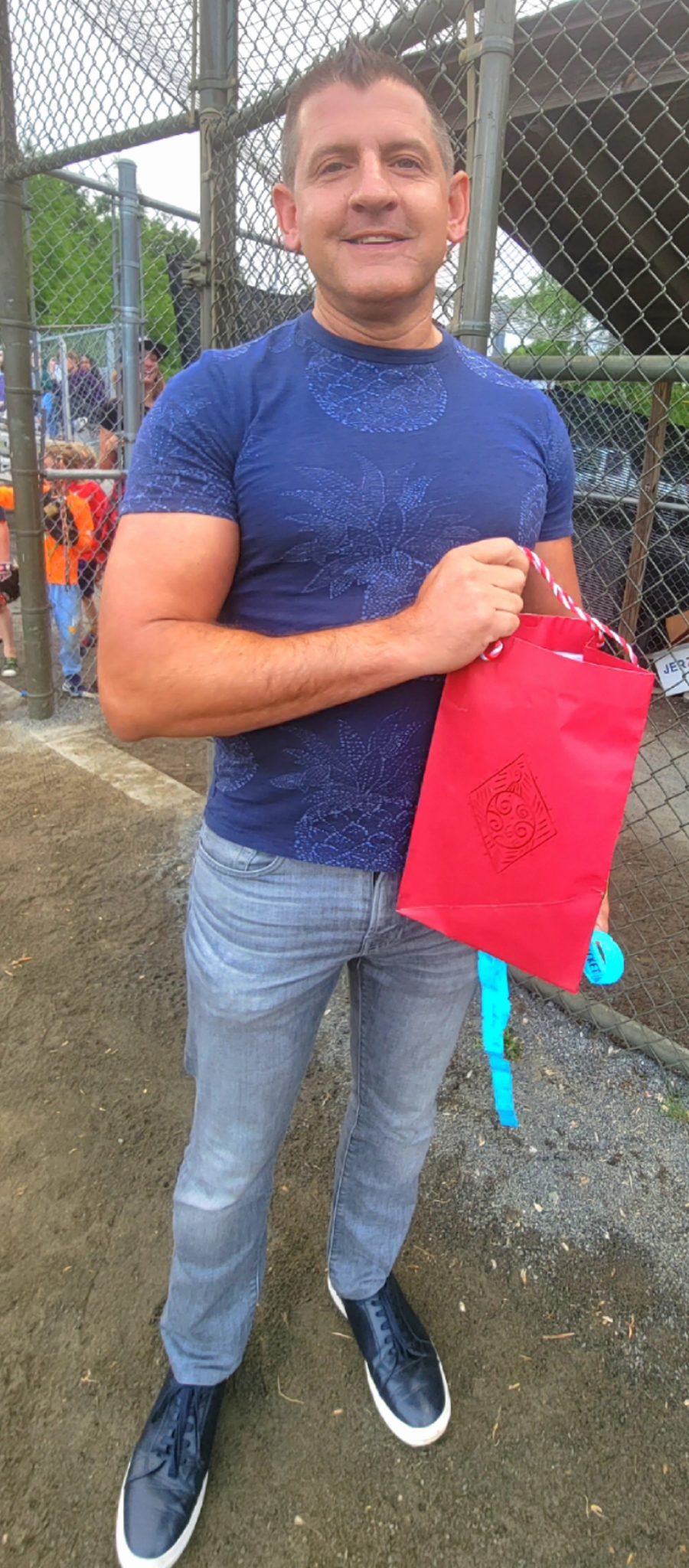 a man hold a bright red bag 