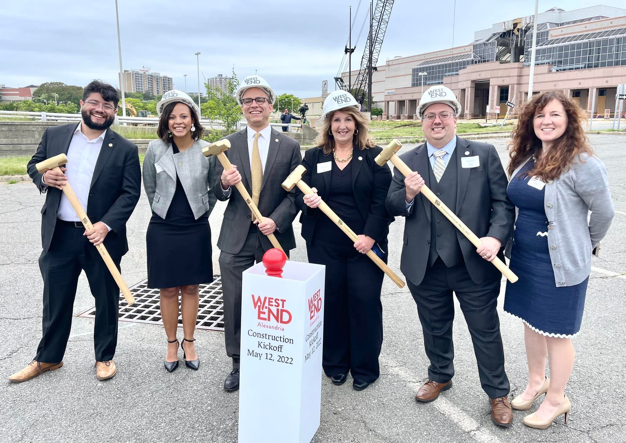 alexandria city council members and mayor wear hard hats and hold mallets to break ground at landmark mall