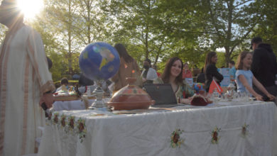 woman at table with worldly artifacts