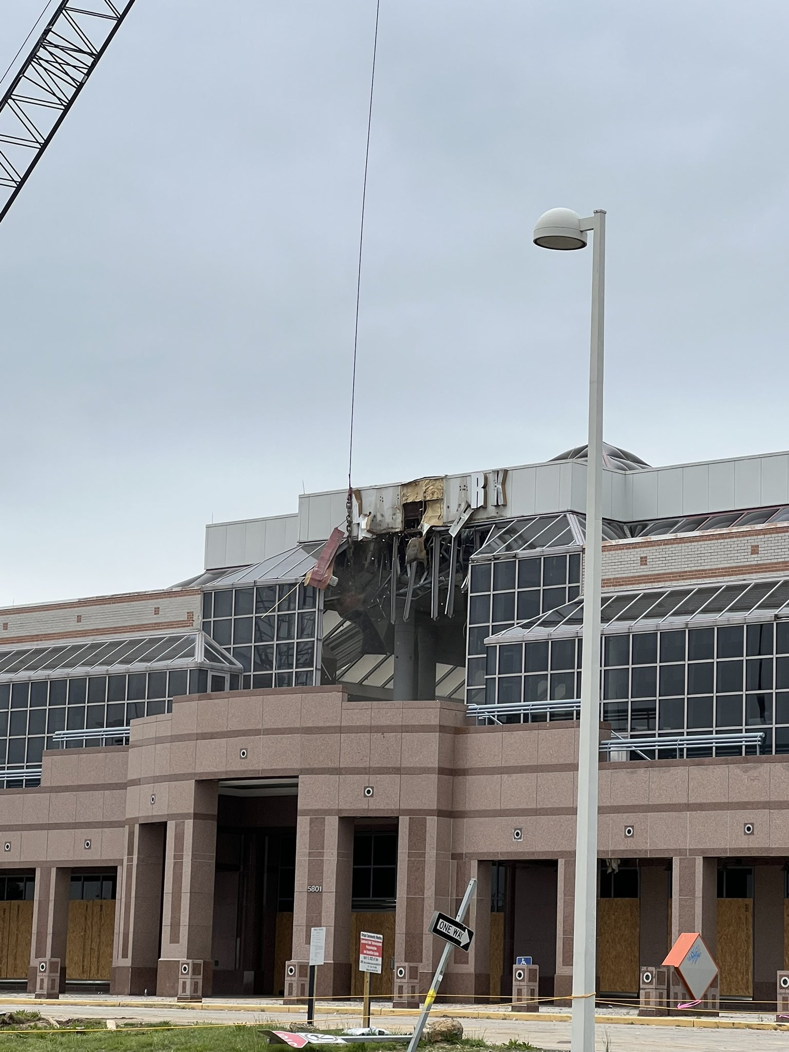 wrecking ball breaks windows on the second floor of a mall