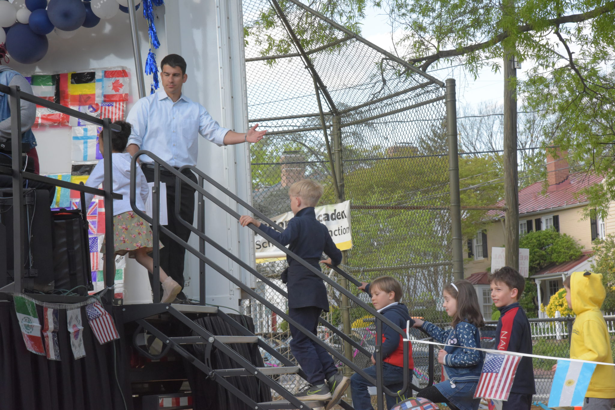 man waves students onto stage