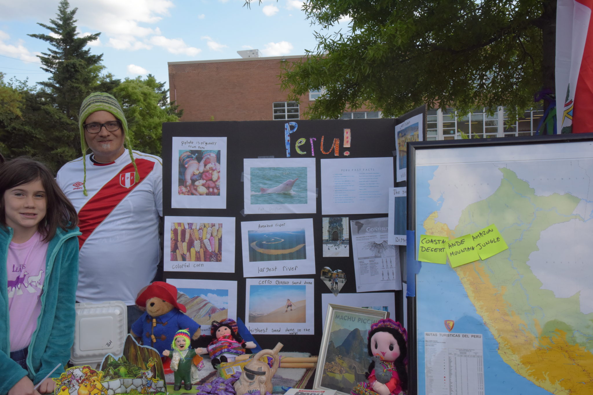 a man stands next to a pasteboard 