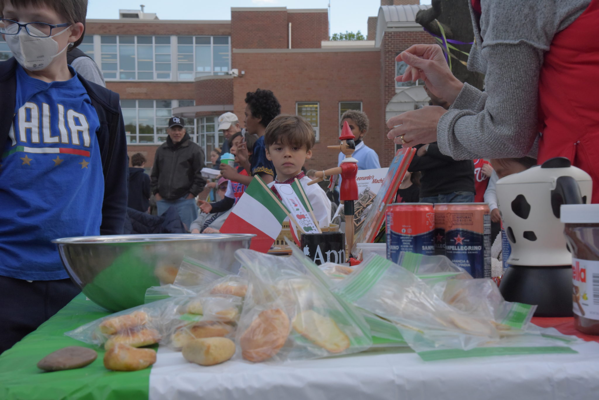 A boy looks at cookies on a table