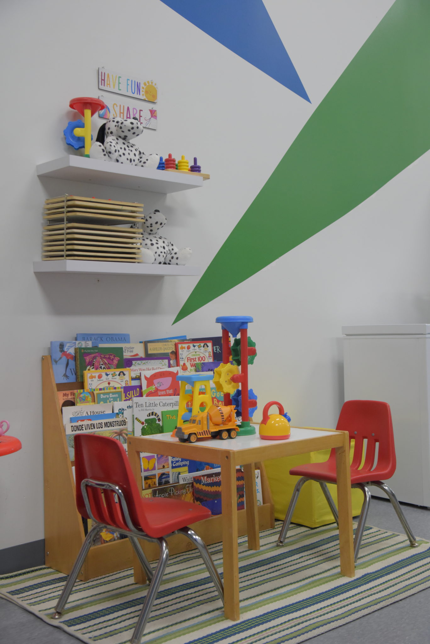 a children's play set with dining table and chairs and books