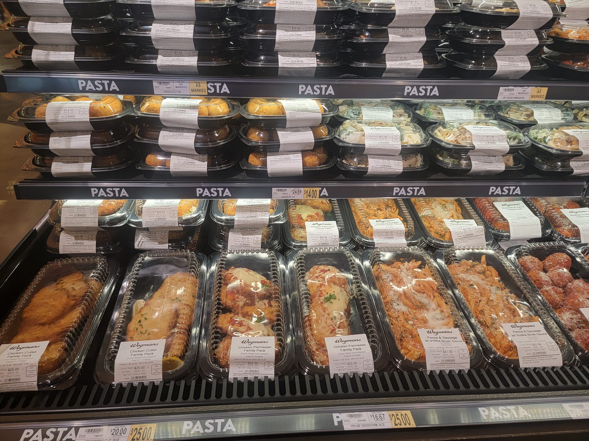 a stand in a Wegmans grocery store with pizzas and sandwiches