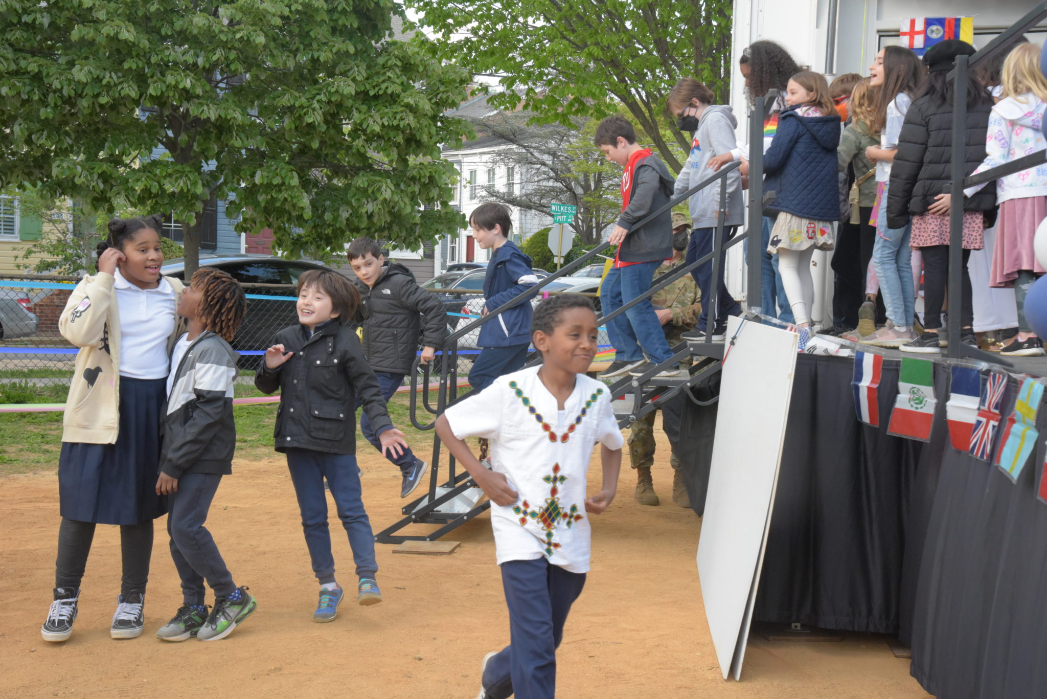 boy runs towards a stage