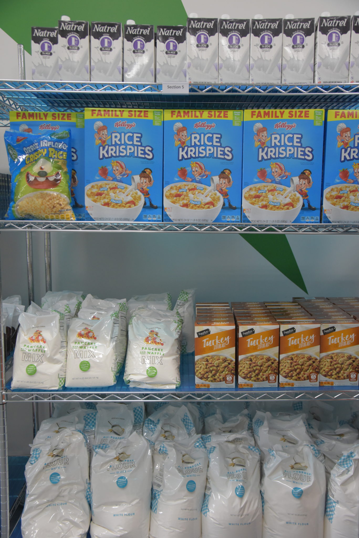 a silver shelf holding non perishable foods, like cereal 