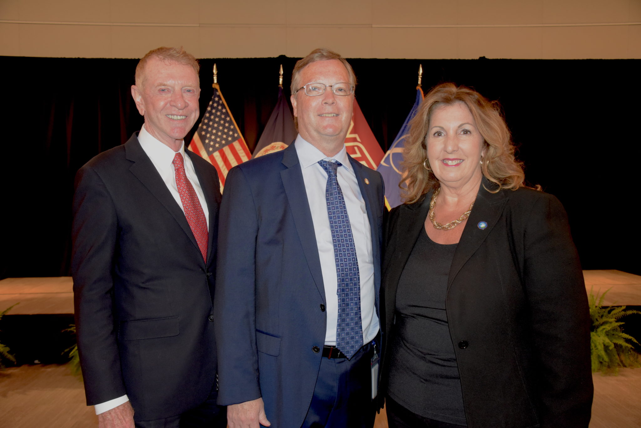 Alexandria Chamber of Commerce President Joe Haggerty stands next to Alexandria City Manager Jim Paragon and Alexandria Vice Mayor Amy Jackson