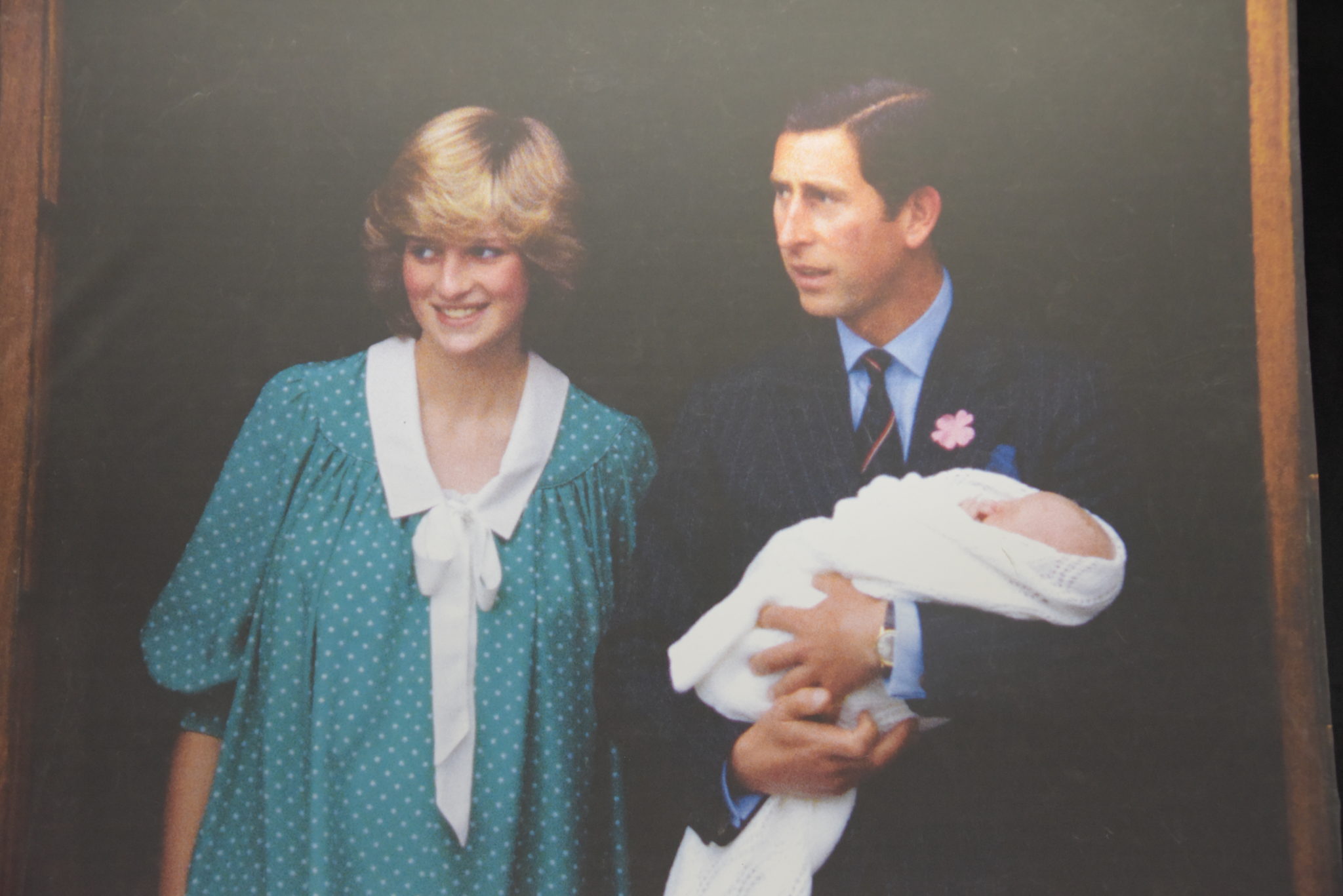 Princess Diana stands next to Prince Charles, who holds their first child Prince William