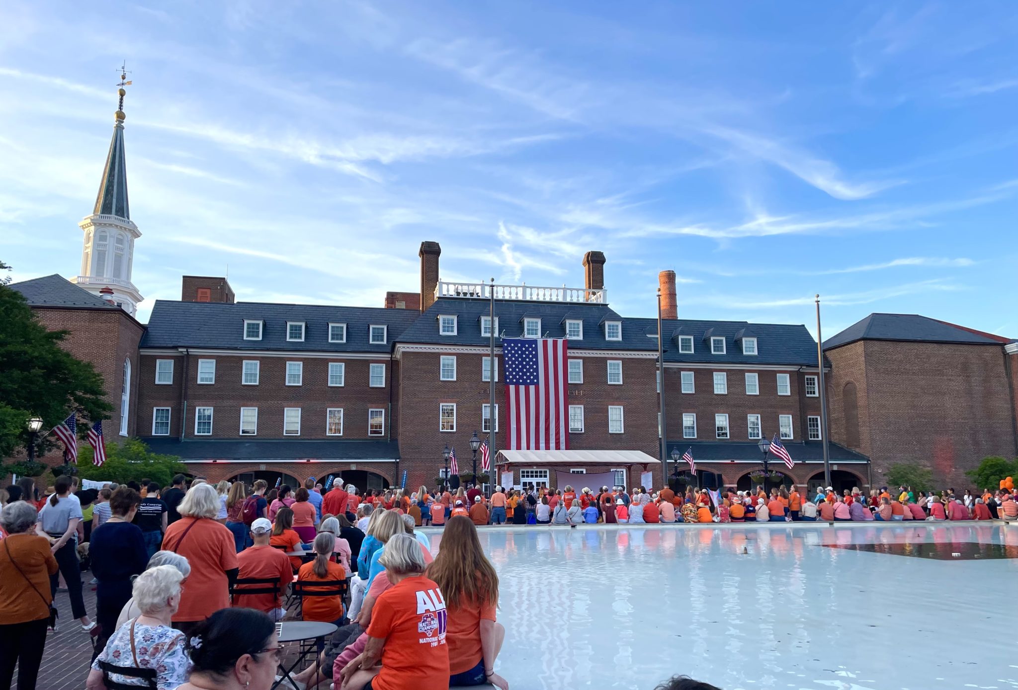 Alexandria's City Hall and Market Square fountain surrounded by people in orange t shirts in support of gun violence victims